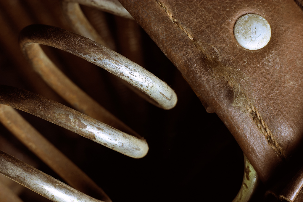 A seat spring from an old bicycle. The image is part of a series of photos of this bike, with each image concentrating on a different component.